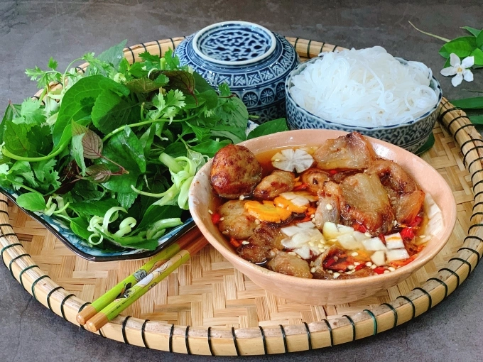 A perfect mess of fresh herbs, soft noodles, and juicy grilled pork dipped in that sweet and savory broth. This is heaven in a bowl.