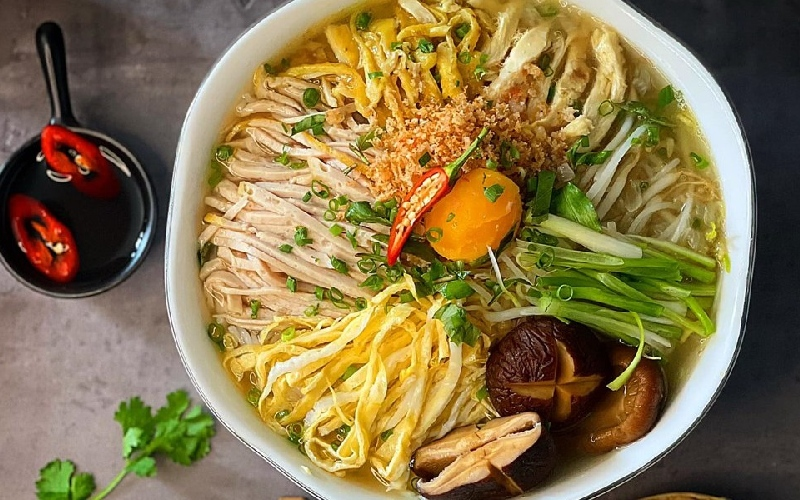 Bún Thang is honestly the most elegant and meticulous bowl of noodles in Hanoi. Every single ingredient is shredded into thin, perfect ribbons like a piece of art.
