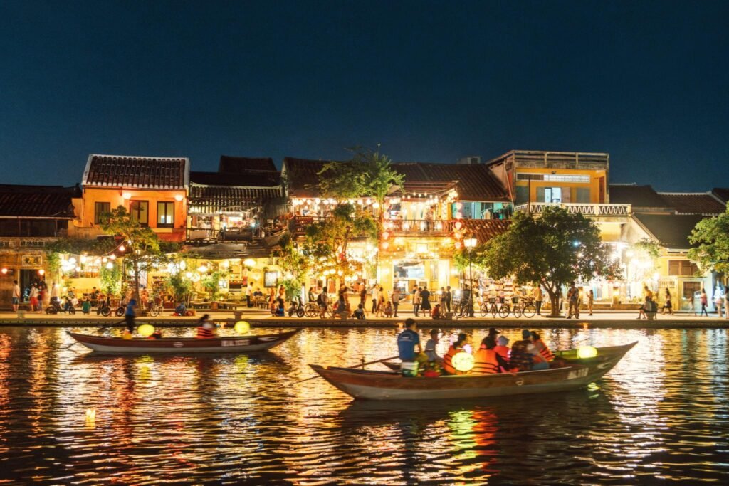 Locals and visitors release floating lanterns onto the river, creating a breathtaking spectacle of light and reflection.
