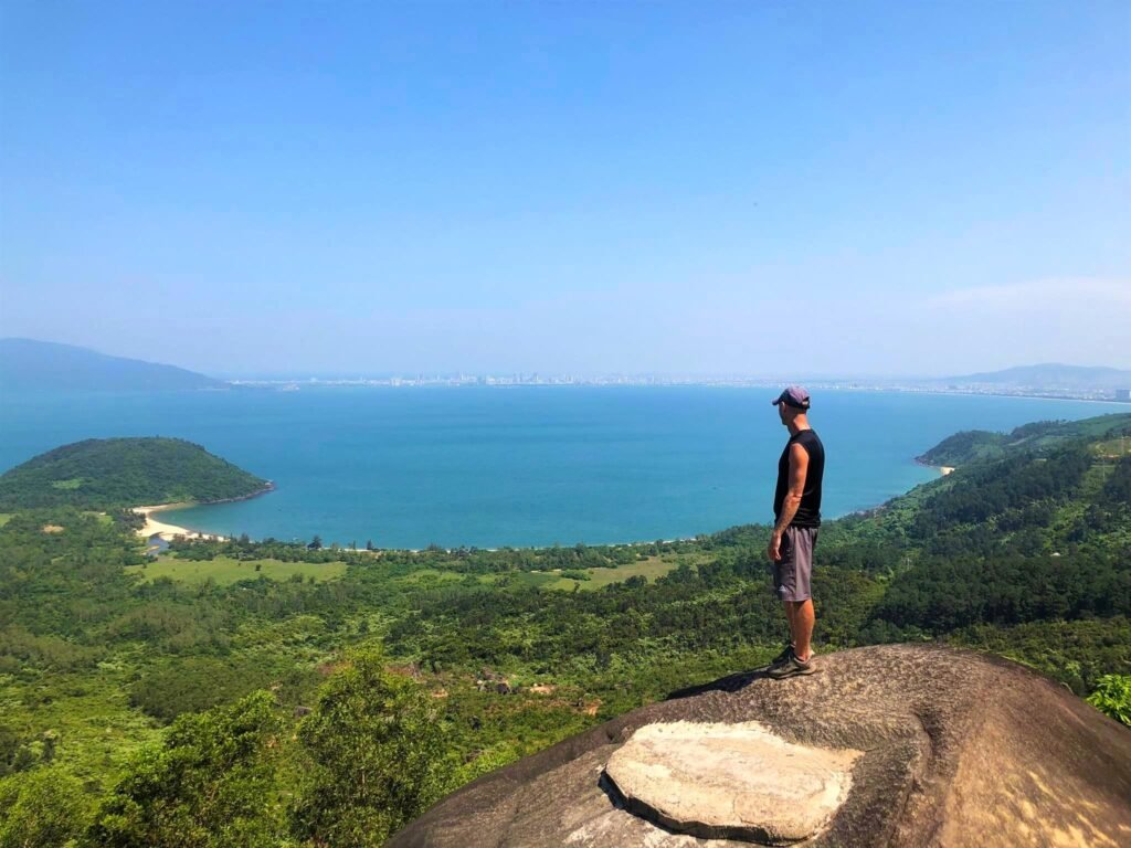 From the higher elevations of Hai Van Pass, riders enjoy sweeping views of Da Nang's coastline stretching endlessly into the horizon.