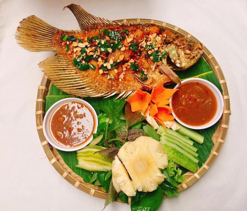 The dining experience is equally unique. Pieces of fish are wrapped in rice paper along with fresh herbs, cucumber, star fruit, green banana, and vermicelli noodles. The rolls are then dipped into a flavorful fish sauce.